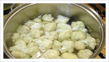 Break up the cauliflower into florets of about 1 in cubes, wash and place in a saucepan of cold salted water.