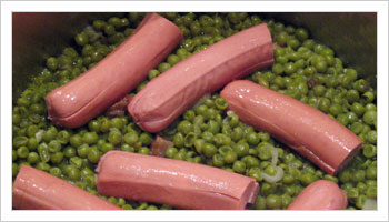 Add frankfurter to the peas when the water has just about evaporated