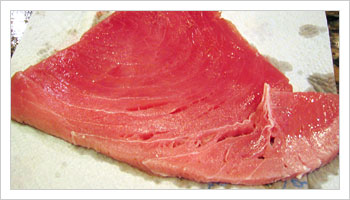 Place tuna steaks in the frying pan after the onion has started to turn transparent