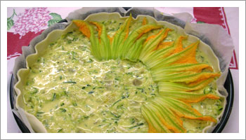 Decora la superficie della torta salata con i fiori di zucca
